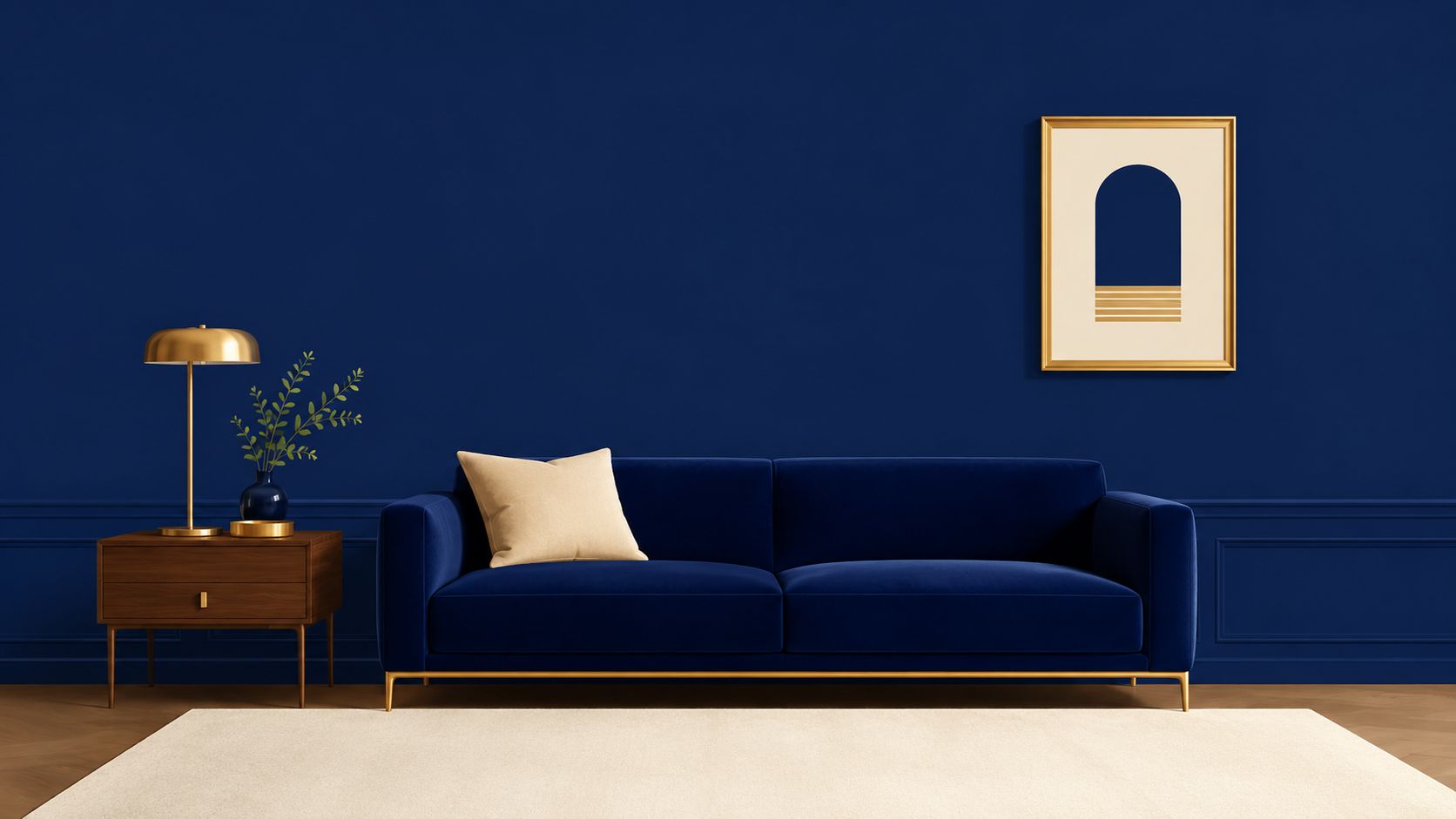 A modern velvet navy blue sofa against a dark blue wall with a gold framed art piece.